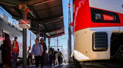 people pass an electric train at a caltrain station