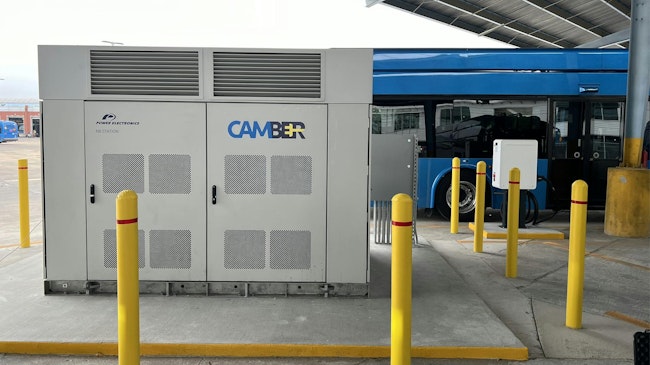 camber charger sits in front of CapMetro electric bus