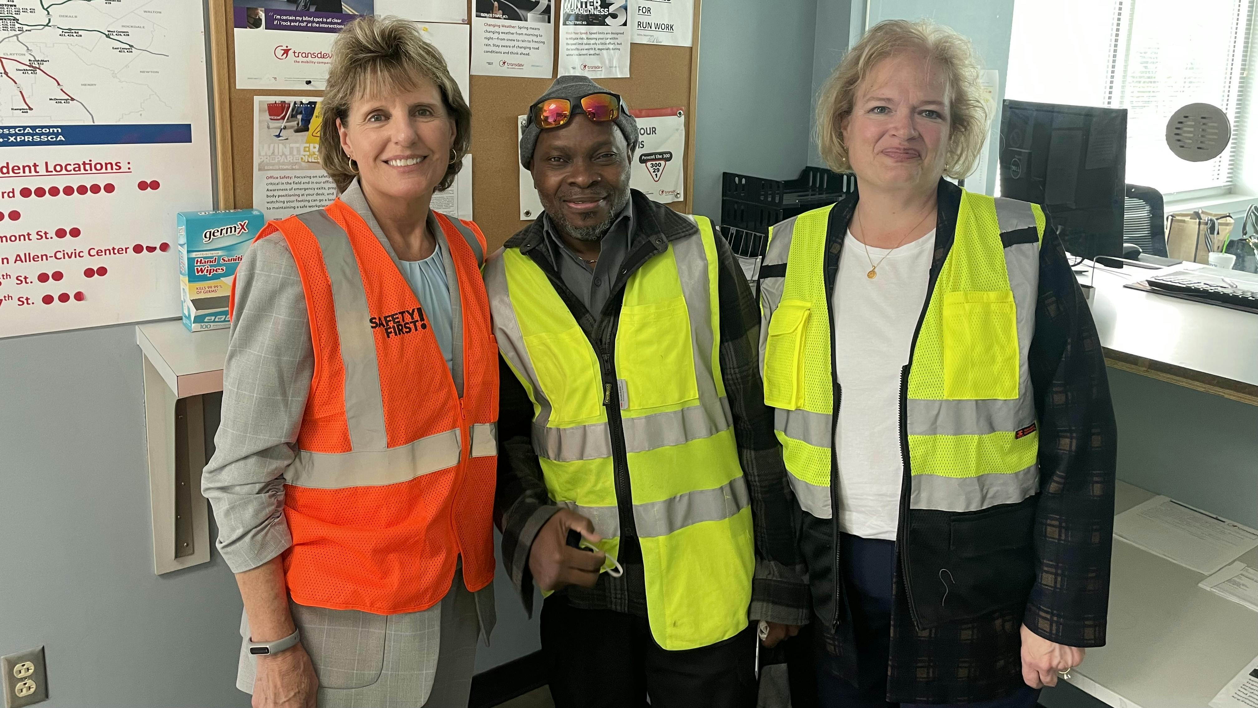 Laura hendricks poses with frontline worker and susan sweat in safety vests
