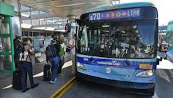 MTA Q70 blue bus waits outside terminal at LaGuardia for passengers to board MTA Q70 blue bus waits outside terminal at LaGuardia for passengers to board