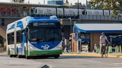 A Swift Orange Line bus drives through Lynnwood City Center Station.