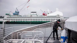 Water taxi crew member fuels the Doc Maynard.