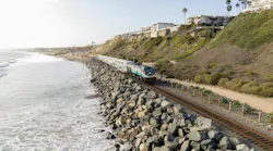 Metrolink train runs on track next to bluffs and the ocean