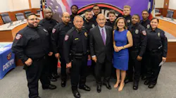 new MPD officer graduates pose with police chief in front of Houston Metro step and repeat