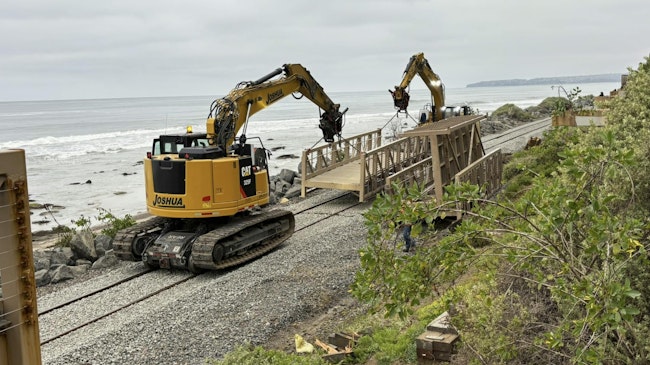 two bulldozers perform work on the rail tracks in San Clemente