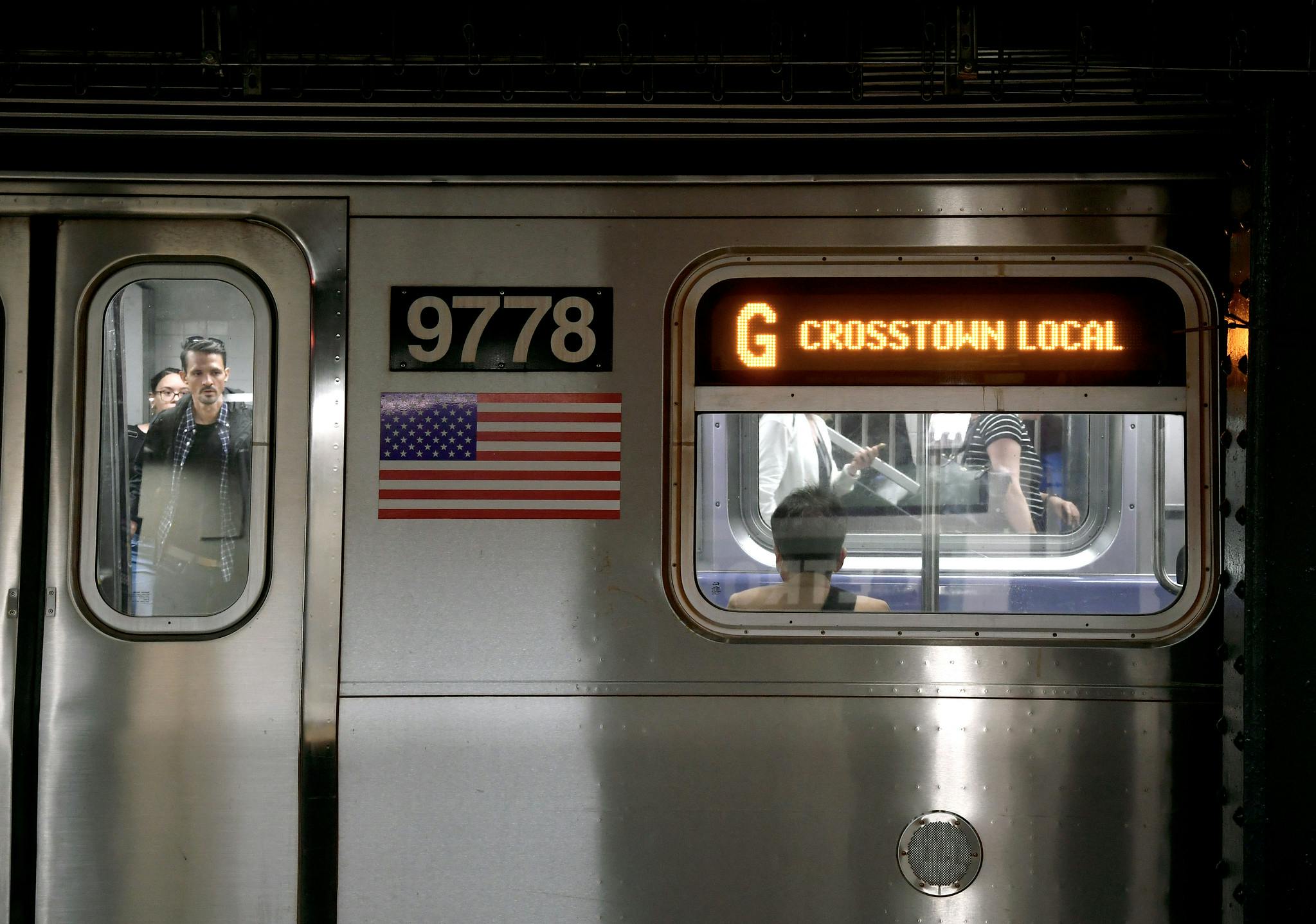 people ride in new york city transit subway G crosstown train