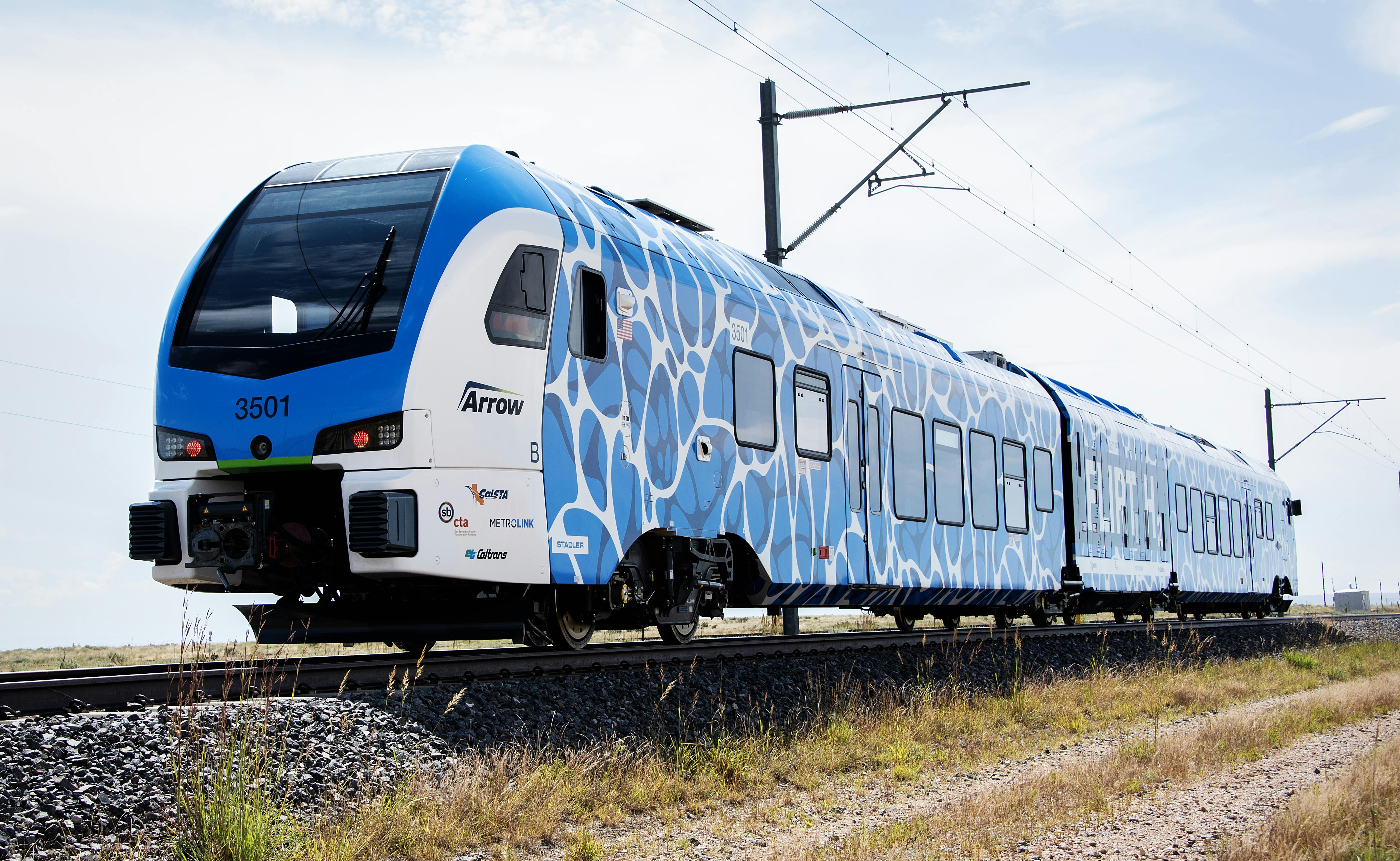 Stadler FLIRT ZEMU train in blue and white wrapping runs on test track at TTC