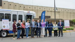 county and pace officials stand in a line in front of a pace cutaway bus to cut a ribbon county and pace officials stand in a line in front of a pace cutaway bus to cut a ribbon