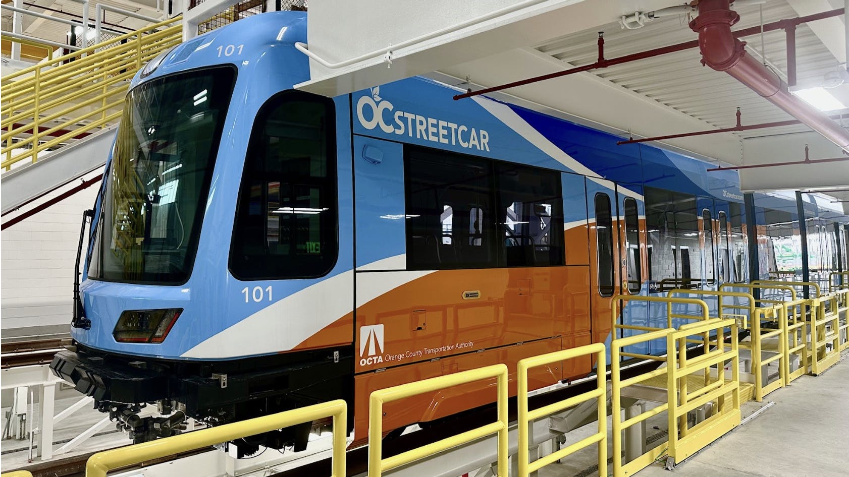 new oc streetcar-branded light-rail train sits in the depot