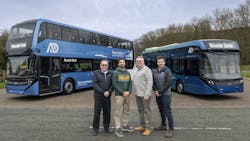 four men pose in front of a blue double decker and 40 foot alexander dennis buses four men pose in front of a blue double decker and 40 foot alexander dennis buses