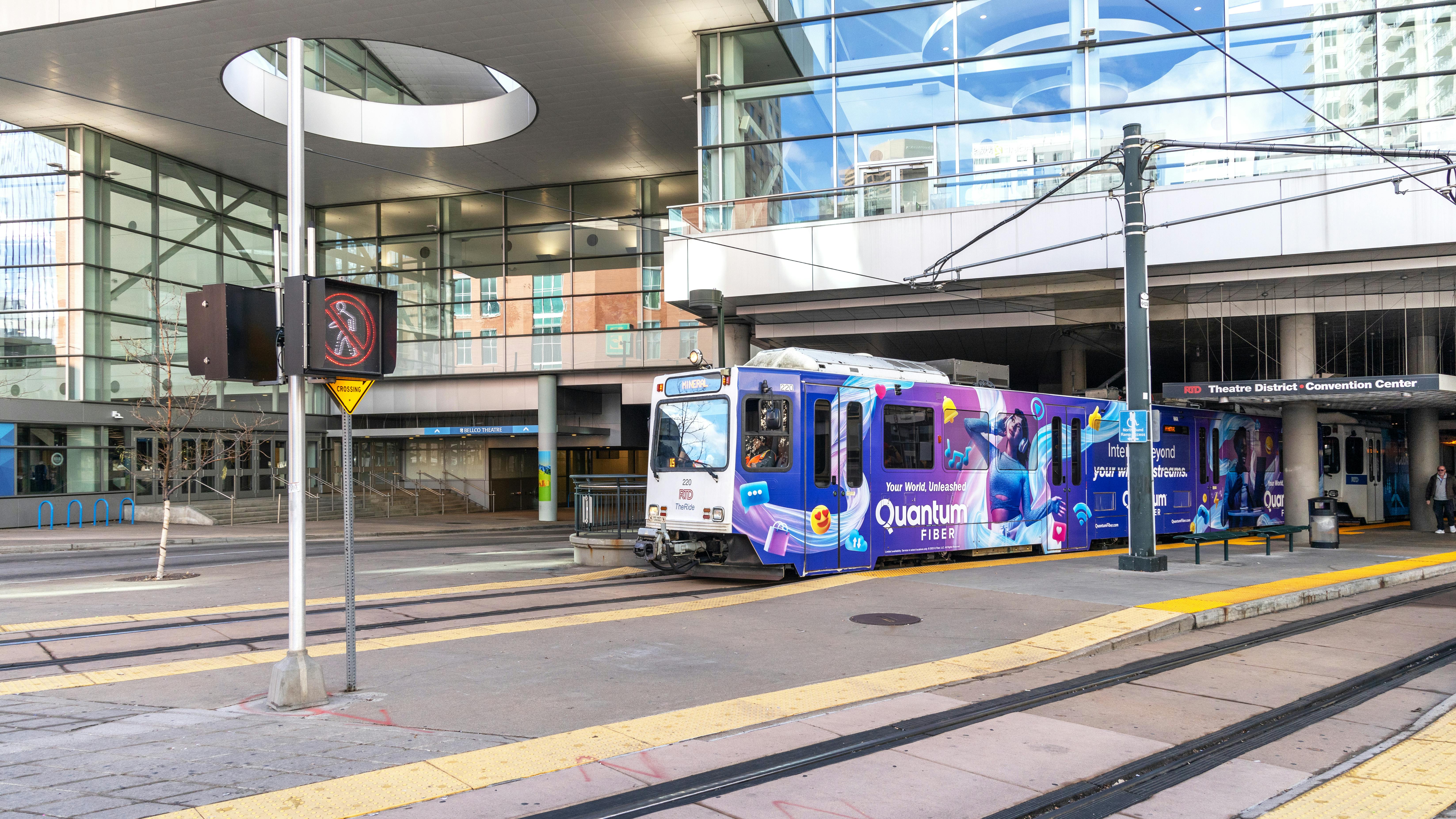 denver RTD light rail train stops at an outdoor station
