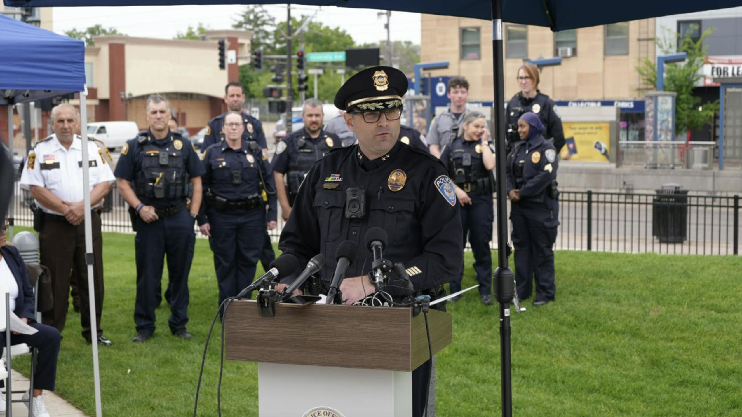 police chief speaks at a podium outside