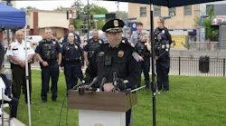 police chief speaks at a podium outside