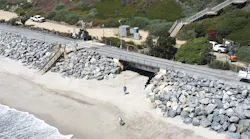 rail tracks running through san clemente near the beach showing large boulders placed along the edige