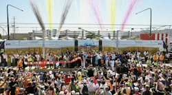crowd gathers in front of valley metro light-rail vehicle