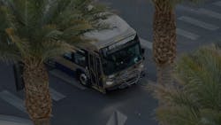RTC bus drives down a street with palm trees on either side RTC bus drives down a street with palm trees on either side