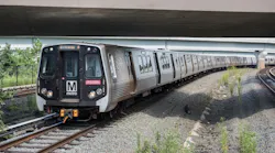a WMATA orange line train operates down a track under an overpass
