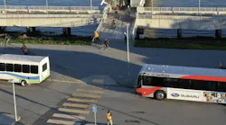 SMCTA branded bus drives down the road near the water front