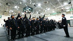 graduating police officers in dress blues stand up and throw their white gloves into the air during their ceremony graduating police officers in dress blues stand up and throw their white gloves into the air during their ceremony