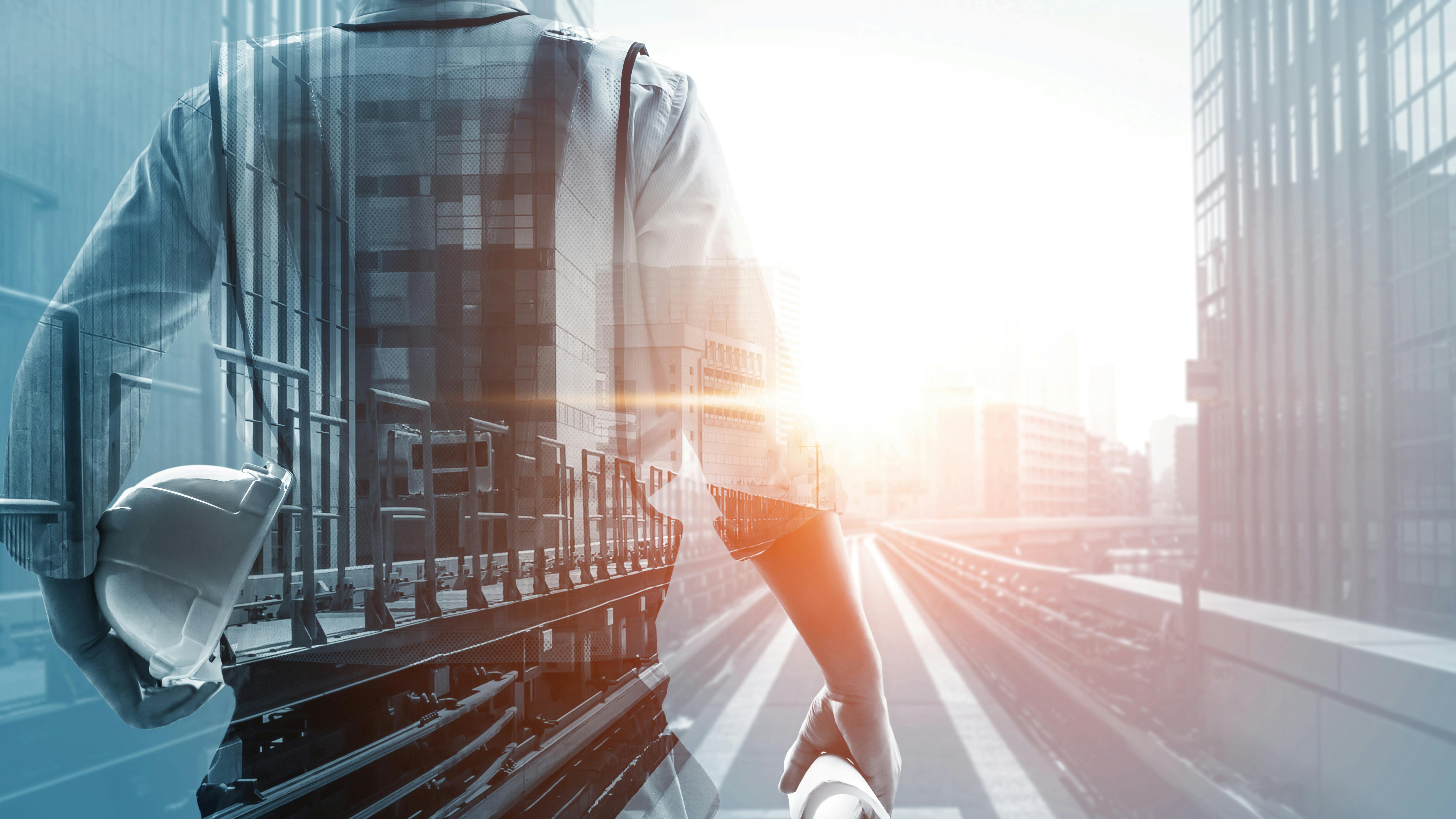 super imposed, layered graphic with rail tracks in urban setting overlayed with the outline of a person's body holding hard hat and papers