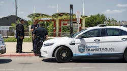 three transit police officers stand outside in front of a CapMetro transit police SUV three transit police officers stand outside in front of a CapMetro transit police SUV