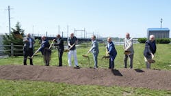 eight men stand in a line outside holding shovels over a fresh pile of dirt eight men stand in a line outside holding shovels over a fresh pile of dirt