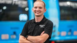Christian bigger headshot in front of a row of parked buses Christian bigger headshot in front of a row of parked buses