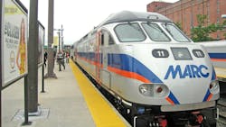 MARC branded diesel locomotive waits at an outside station platform MARC branded diesel locomotive waits at an outside station platform