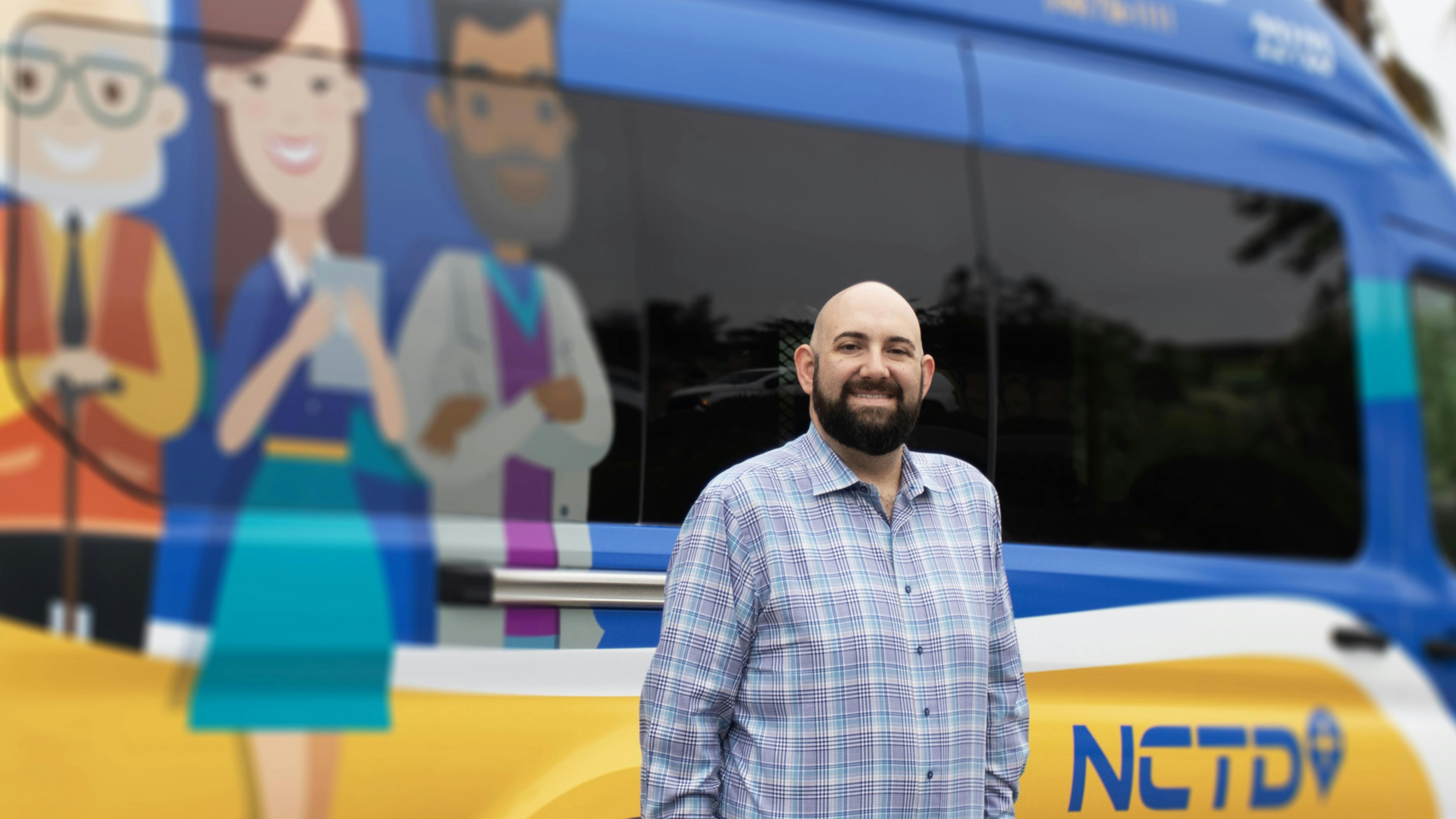 Nicholas A. Sofoul, AICP. next to a NCTD vehicle.