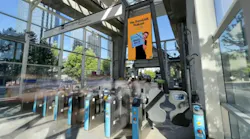 picture of a station entrance that shows the fare gates and a tall signage display
