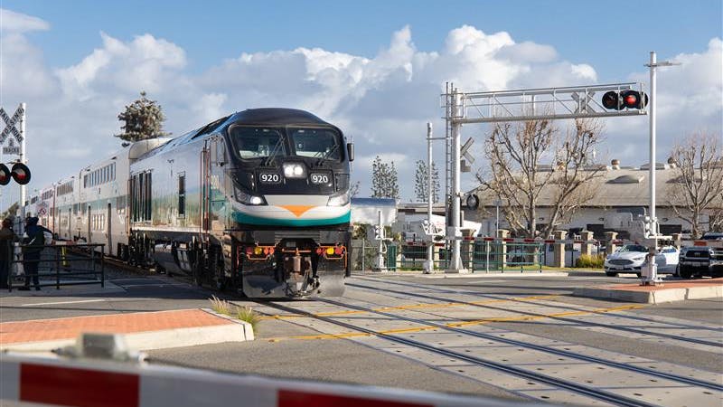 a metrolink train goes through an at-grade crossing