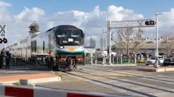 a metrolink train goes through an at-grade crossing