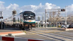 a metrolink train goes through an at-grade crossing a metrolink train goes through an at-grade crossing