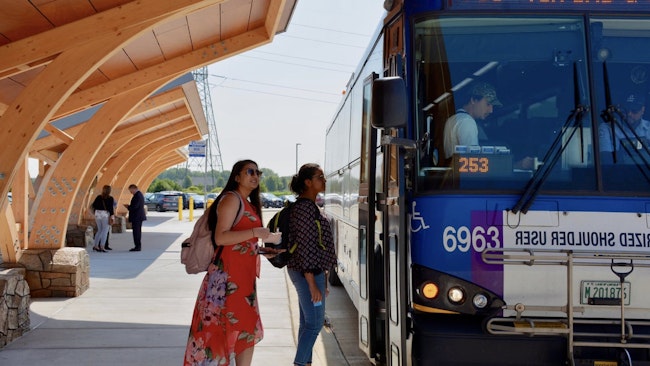 two people board a pace bus