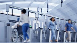 people walk through Cubic's FenX fare gates people walk through Cubic's FenX fare gates