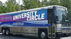 a laketran commuter bus with a now serving university circle bus wrap