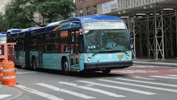 New York City bus travels down a main street in downtown New York City New York City bus travels down a main street in downtown New York City
