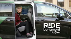 Passenger sits in the rear seat of a RIDE Longmont transit van.