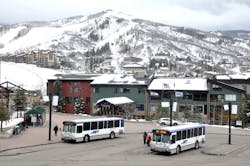Buses sit parked at a ski complex. Buses sit parked at a ski complex.