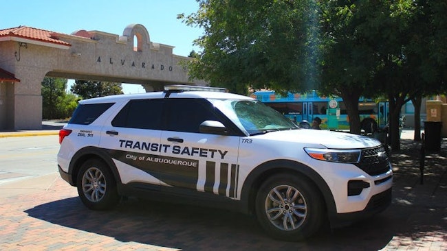 A Transit Safety enforcement vehicle sits parked near a bus stop.