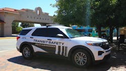 A Transit Safety enforcement vehicle sits parked near a bus stop. A Transit Safety enforcement vehicle sits parked near a bus stop.