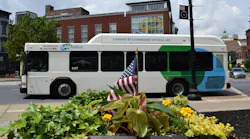 a CNG-powered LANTA-branded bus drives down a town street