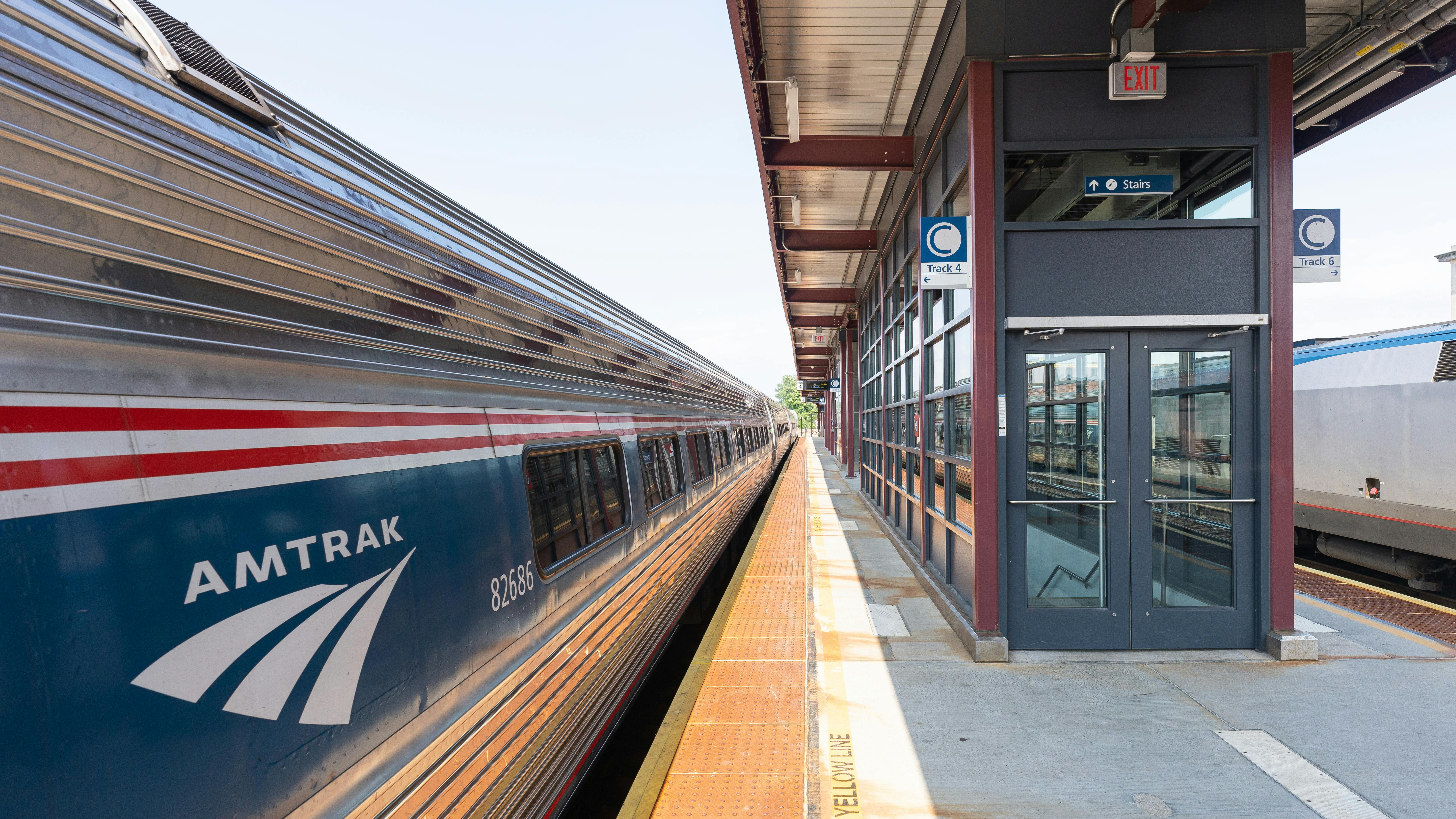 An Amtrak train sits at an elevated platform in Springfield, Mass.