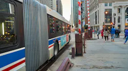 A CTA bus sits at a bus stop.