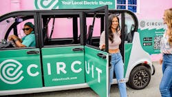 A woman exits a Circuit electric shuttle. A woman exits a Circuit electric shuttle.
