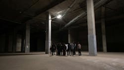 group of students gather around a presentation in the underground The Portal construction site group of students gather around a presentation in the underground The Portal construction site