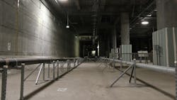 Two utility pipes run down the center of a future rail corridor, tracing the path where train tracks will eventually be laid. Two utility pipes run down the center of a future rail corridor, tracing the path where train tracks will eventually be laid.