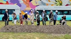Members of the converging agencies all hold shovels that have just taken the first scoop out of the dirt at the site of what will be the new transit center.