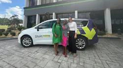 Launching members stand in front of a Shift On Demand shuttle van.