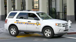 A Ford Escape wearing the BART PD livery sits in front of of a Berkeley station.